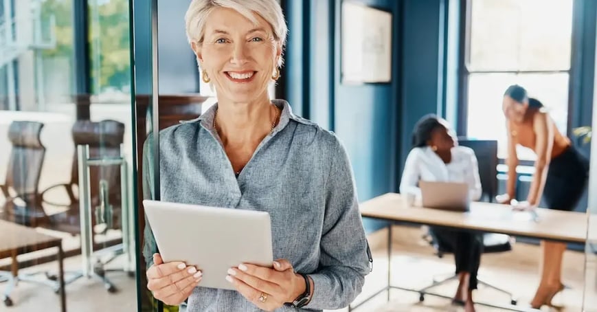 A female Executive Assistant holding a survey in her hands
