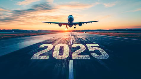 An airplane about to land with the numbers 2025 written across the tarmac