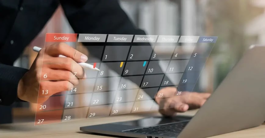 An Executive Assistant looking at a calendar to help write a meeting objective