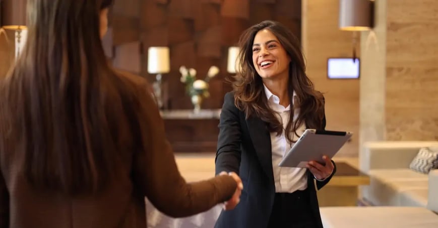 EA shaking attendees hand at a business meeting