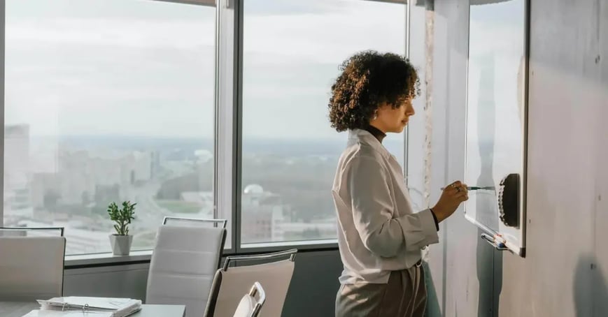 EA writing her budget plan on a whiteboard