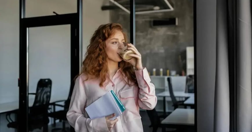Female Executive Assistant drinking a cup of coffee