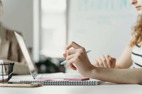 Executive Assistant working at her desk, drafting a simple meeting objective