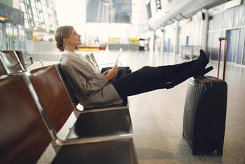 A woman sitting in a chair at the airport