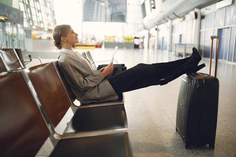 A woman sitting in a chair at the airport